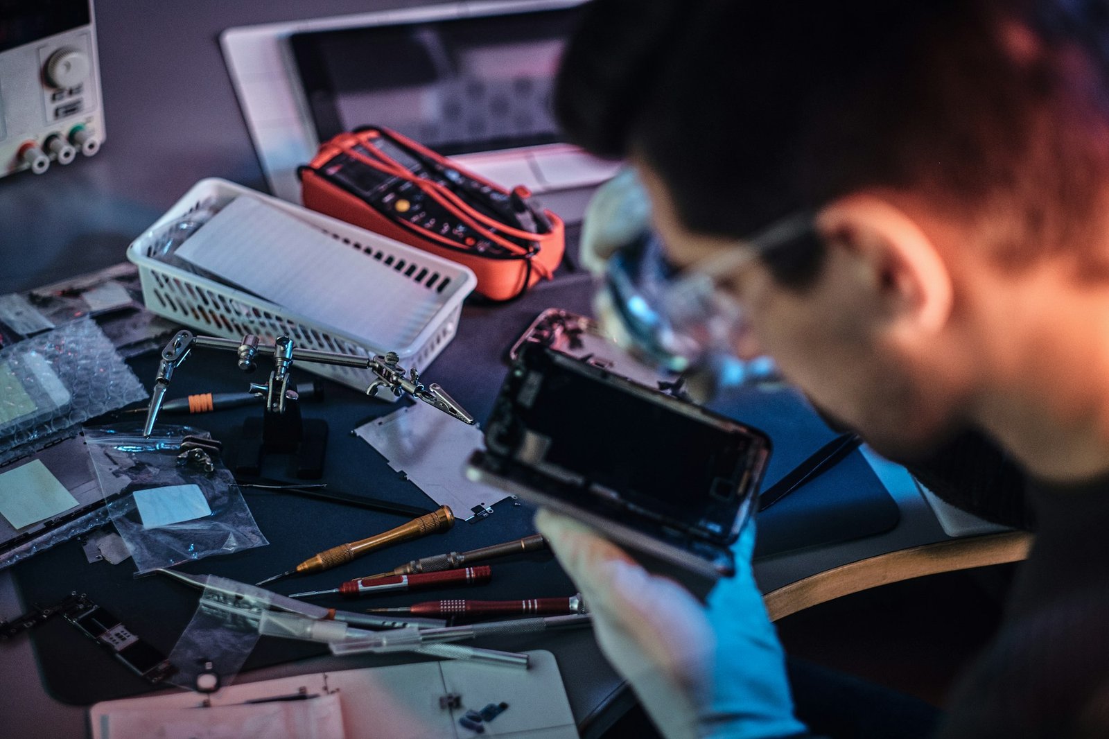 Electronic technician repair damaged smartphone in the workshop