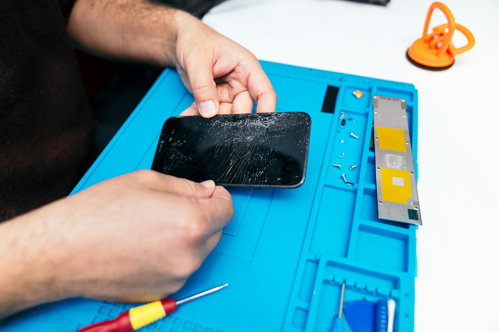 Expert Technician Repairing a Broken Smartphone Screen